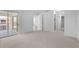 Spacious bedroom with neutral carpet, slider to screened porch, and entrances to bath and closet at 5800 Sabal Trace Dr # 1302, North Port, FL 34287