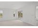 Bright bedroom with neutral carpet, slider to screened porch and natural light from the windows at 5800 Sabal Trace Dr # 1302, North Port, FL 34287