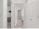 Hallway with neutral color and doors to bathroom, closet, and storage at 5800 Sabal Trace Dr # 1302, North Port, FL 34287