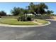 Well-manicured landscaping surrounds the roundabout, with trees, shrubs, and brick pavers at 5800 Sabal Trace Dr # 1302, North Port, FL 34287