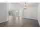 Bright living room with tile flooring and ample natural light from windows and sliding glass doors to the balcony at 5800 Sabal Trace Dr # 1302, North Port, FL 34287