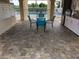 Poolside seating area with tables, chairs, and a view of the community pool at 5800 Sabal Trace Dr # 1302, North Port, FL 34287