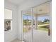 View from the screened porch showing lush landscaping and sunny skies at 5800 Sabal Trace Dr # 1302, North Port, FL 34287