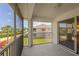 Screened porch with view of adjacent house at 5800 Sabal Trace Dr # 1302, North Port, FL 34287