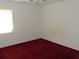 Bright bedroom with a window to let in natural light and red carpeting at 582 Reading Nw St, Port Charlotte, FL 33952
