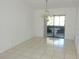 Dining area with tile flooring, chandelier lighting, and access to the patio through sliding glass doors at 582 Reading Nw St, Port Charlotte, FL 33952