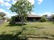 Rear view of the home featuring a screened-in porch at 582 Reading Nw St, Port Charlotte, FL 33952