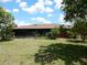 Exterior of home with screen patio in landscaped backyard at 582 Reading Nw St, Port Charlotte, FL 33952