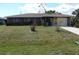 Charming single-story home featuring an attached garage and well-maintained front yard at 582 Reading Nw St, Port Charlotte, FL 33952