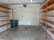 Spacious garage with wooden shelving units for organized storage at 582 Reading Nw St, Port Charlotte, FL 33952