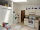 Bright kitchen with white cabinets, laminate countertops, and a skylight at 582 Reading Nw St, Port Charlotte, FL 33952