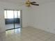 The living room features tile flooring, a ceiling fan, and sliding glass door access to the patio at 582 Reading Nw St, Port Charlotte, FL 33952
