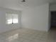 The living room features tile flooring, bright natural light, and a neutral color palette at 582 Reading Nw St, Port Charlotte, FL 33952