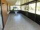 Enclosed patio features tile flooring, a table, and screened windows for a relaxing outdoor experience at 582 Reading Nw St, Port Charlotte, FL 33952