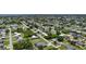 Sprawling aerial view of a residential neighborhood featuring numerous single-Gathering homes and lush greenery at 582 Ridgewood Nw St, Port Charlotte, FL 33952