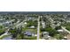 Expansive aerial shot of a residential neighborhood with lush greenery and a view of the distant waterfront at 582 Ridgewood Nw St, Port Charlotte, FL 33952