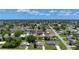 Wide aerial shot captures a suburban neighborhood under a blue sky with scattered clouds at 582 Ridgewood Nw St, Port Charlotte, FL 33952