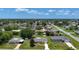 Bright yellow home features manicured lawns and is surrounded by mature trees in a quiet neighborhood at 582 Ridgewood Nw St, Port Charlotte, FL 33952