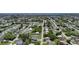 Wide aerial shot showcasing a serene neighborhood with lush greenery and a glimpse of the distant waterfront at 582 Ridgewood Nw St, Port Charlotte, FL 33952