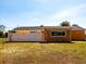 Backyard view of a single-story home with a fenced yard at 582 Ridgewood Nw St, Port Charlotte, FL 33952