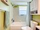 Bright bathroom with a shower-tub, modern fixtures, and a wall-mounted vanity at 582 Ridgewood Nw St, Port Charlotte, FL 33952