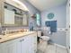 Bright bathroom with a vanity and sink, complemented by tiled floors and blue accents at 582 Ridgewood Nw St, Port Charlotte, FL 33952