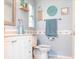 Bright bathroom with blue walls, white vanity, and coastal-themed decorations at 582 Ridgewood Nw St, Port Charlotte, FL 33952