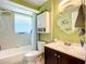 Bathroom featuring a shower over tub, vanity, modern fixtures and bright tile at 582 Ridgewood Nw St, Port Charlotte, FL 33952