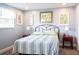 Serene bedroom featuring a metal frame bed, neutral carpet, and soft blue walls at 582 Ridgewood Nw St, Port Charlotte, FL 33952