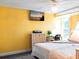 Bedroom with yellow walls, a tv, and natural light at 582 Ridgewood Nw St, Port Charlotte, FL 33952