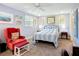Bright bedroom featuring a comfortable bed and charming red accent chair with coordinated ottoman at 582 Ridgewood Nw St, Port Charlotte, FL 33952