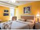 Bedroom with yellow walls, a wooden headboard and natural light at 582 Ridgewood Nw St, Port Charlotte, FL 33952
