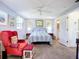 Large bedroom featuring a sitting area, bed, and ensuite bathroom at 582 Ridgewood Nw St, Port Charlotte, FL 33952