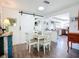 Bright dining area with white table set and modern sliding barn door detail, leading to the kitchen at 582 Ridgewood Nw St, Port Charlotte, FL 33952