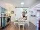 Inviting dining space with barn door and an open flow to the kitchen area with natural light at 582 Ridgewood Nw St, Port Charlotte, FL 33952
