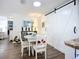 This dining area features a white table and chairs, complemented by a stylish sliding barn door detail at 582 Ridgewood Nw St, Port Charlotte, FL 33952