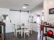 Bright dining area with white table and chairs, white barn doors, and wood floors at 582 Ridgewood Nw St, Port Charlotte, FL 33952
