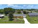Charming yellow single-story home with a gray roof, well-maintained lawn, and a clear blue sky background at 582 Ridgewood Nw St, Port Charlotte, FL 33952