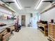 Neat garage featuring a workbench, shelving, and plenty of space for storage at 582 Ridgewood Nw St, Port Charlotte, FL 33952