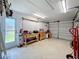 Organized garage space with a pegboard, workbench, tools, and ample storage area at 582 Ridgewood Nw St, Port Charlotte, FL 33952