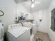 Functional laundry room with a washing machine, dryer, and sink for added convenience at 582 Ridgewood Nw St, Port Charlotte, FL 33952