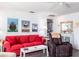 Cozy living room with bright decor, featuring red sofa and nautical themed artwork at 582 Ridgewood Nw St, Port Charlotte, FL 33952