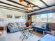 Cozy living room with natural light, comfortable seating, and unique ceiling beam detail at 582 Ridgewood Nw St, Port Charlotte, FL 33952