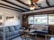 Cozy living room with wood paneled walls, a plaid sofa, and comfortable seating at 582 Ridgewood Nw St, Port Charlotte, FL 33952