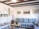 Comfortable living room boasts a blue plaid sofa, beamed ceiling, and coastal decor accents at 582 Ridgewood Nw St, Port Charlotte, FL 33952