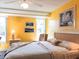 Sunny main bedroom featuring large windows, a queen size bed, and accent walls at 582 Ridgewood Nw St, Port Charlotte, FL 33952