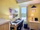 A bright home office featuring a large window, a workspace, and storage at 582 Ridgewood Nw St, Port Charlotte, FL 33952