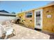 The fenced patio offers outdoor dining, a grill, seating area, and backyard access, perfect for relaxation at 582 Ridgewood Nw St, Port Charlotte, FL 33952