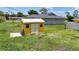 The backyard features a yellow storage shed, ideal for keeping tools and equipment organized at 582 Ridgewood Nw St, Port Charlotte, FL 33952