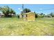 Bright yellow shed in the backyard, providing extra storage space for outdoor equipment at 582 Ridgewood Nw St, Port Charlotte, FL 33952